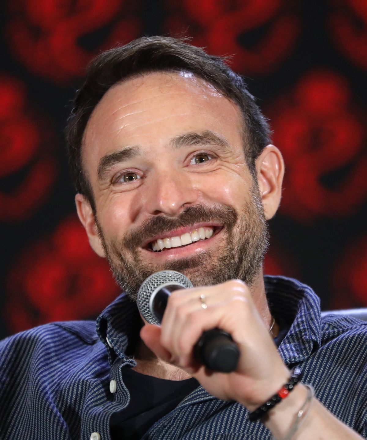 Charlie Cox sorridente al microfono durante un panel di Daredevil, attore britannico interprete di Matt Murdock nel Marvel Cinematic Universe