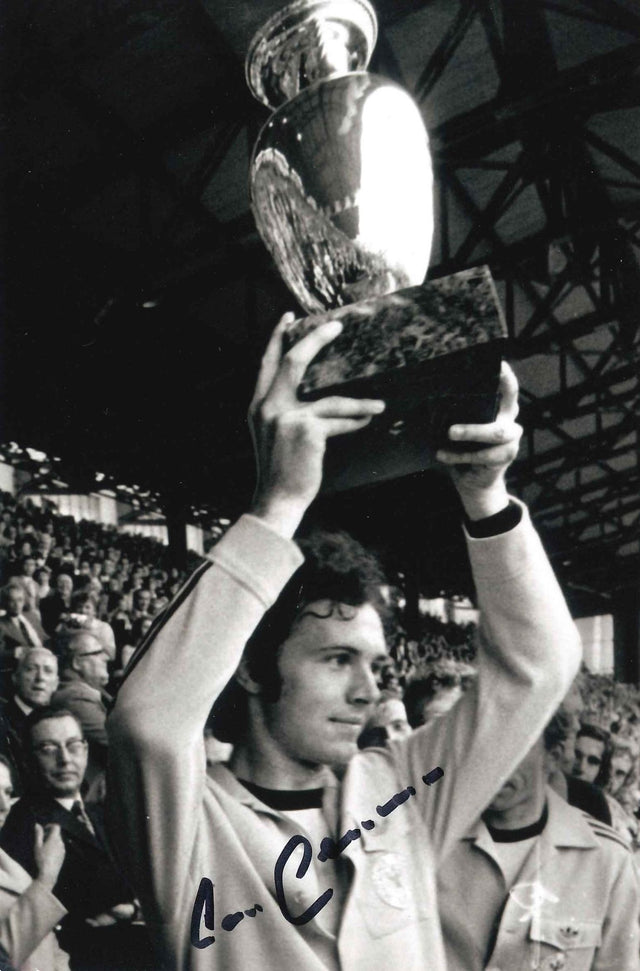 Fotografia autografata Franz Beckenbauer Der Kaiser Bayern Monaco solleva la Coppa dei Campioni anni Settanta tuta bianca Adidas bianco e nero – autografo pennarello blu – 15,5x10 cm