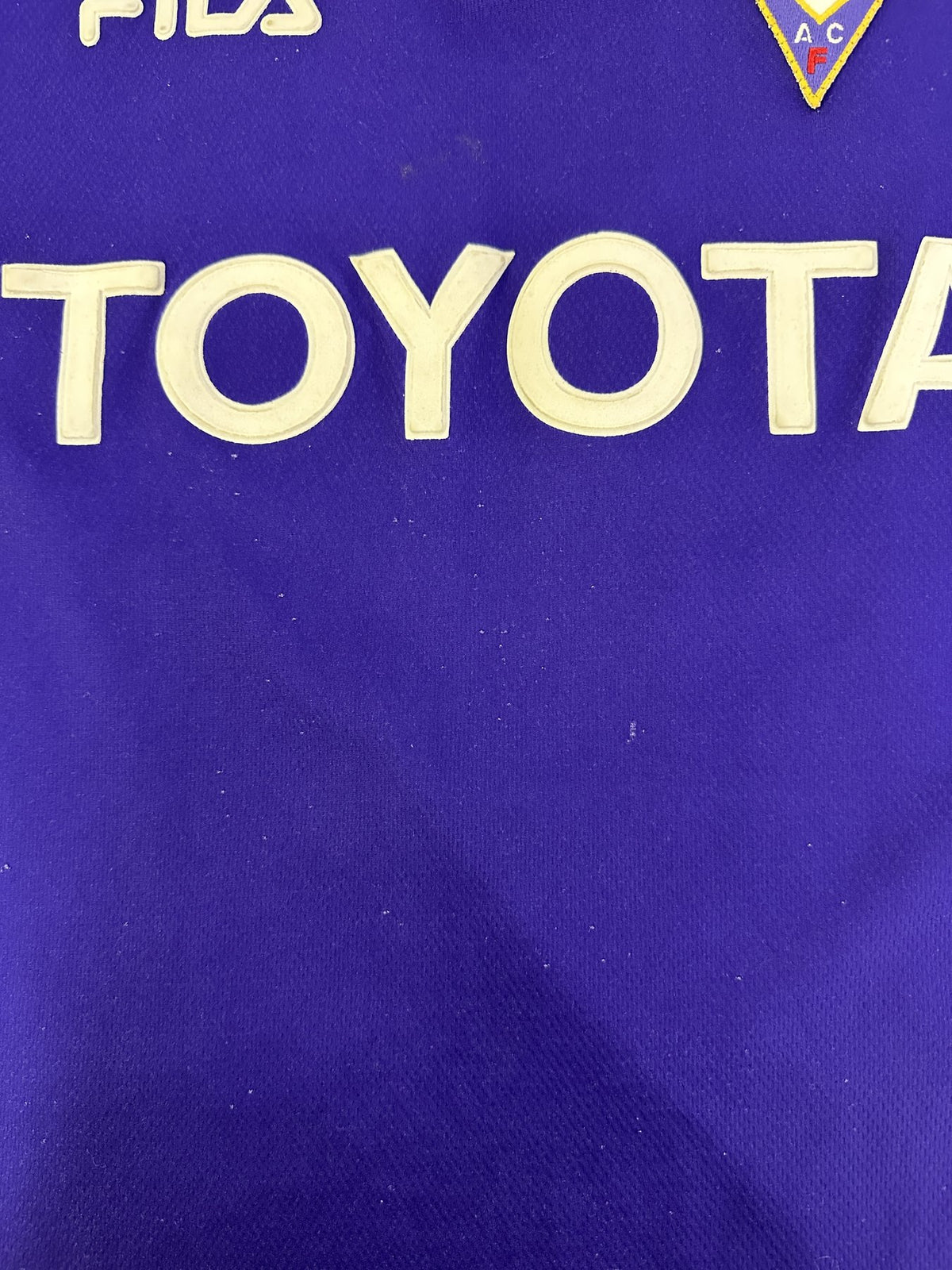 Dettaglio piccoli segni di usura zona sponsor Toyota maglia Fiorentina Home 1999-00
