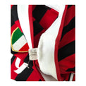 Cartellino Adidas con codice V13457 e data 10/11 accanto allo scudetto della maglia Milan 2011/12